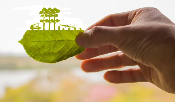 Aus einem Blatt geschnittene Silhouette von abgeholzten Bäumen und Lkw